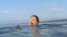Busty vamp Aneta Kora slips into the sea for an aquatic orgasm