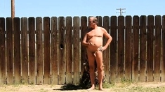 A daddy parading around naked in his backyard.