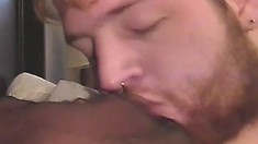 Bearded white guy goes down on his hung friend's black man meat